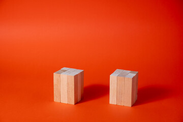 Wooden blank cubic stands podiums on a red background.