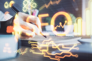 Multi exposure of woman's hands making notes with SEO icon. Concept of Search engine optimization