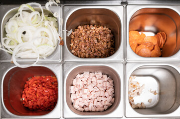 Top view of metal container with pizza ingredients