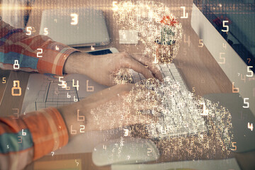 Technology theme hologram with man working on computer on background. High tech concept. Double exposure.