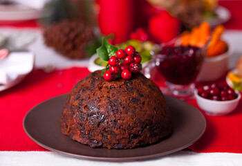 Fototapeta na wymiar Traditional Christmas pudding with holly on top.