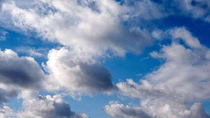 Naklejka na ściany i meble Fluffy clouds, background from clouds, beautiful cloudy sky.