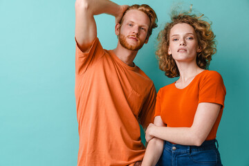 Portrait of beautiful young couple standing isolated