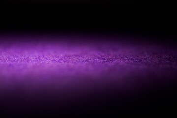 An illuminated purple carpet in the dark
