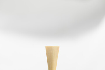 A bassoon reed on a white background