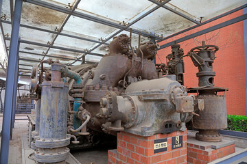 Fototapeta na wymiar The rusty turbine generator lay idle in a corner of the factory