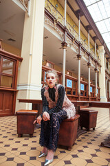 Fototapeta na wymiar young pretty blond girl posing in fashion style at vintage europe hall interior, lifestyle rich people concept