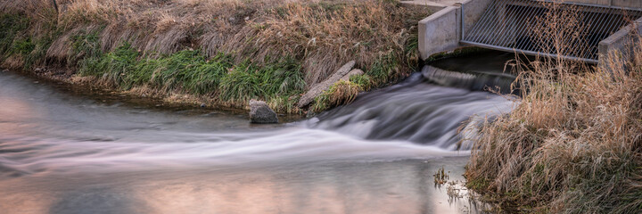 Processed and cleaned sewage flowing out from water reclamation facility to a river or channel,...