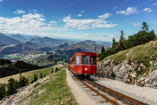 SCHAFBERGBAHN Cog Railway running from St. Wolfgang up the Schafberg, Austria.Journey to the top of Alps through lush fields and green forests.Beautiful mountain panorama.View of lake Wolfgangsee