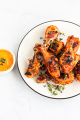 Griiled Chicken Drumsticks Garnished with Fresh Thyme and Other Condiments Top Down Vertical Photo