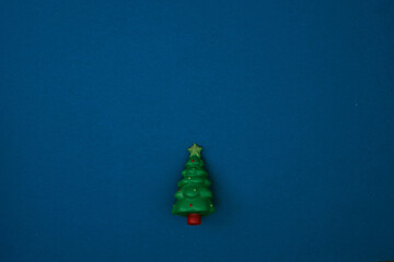 Toy tree blue background. New Year's decor. Copy space, mock up.