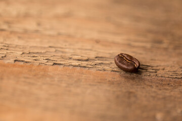 A coffee bean on a wood table