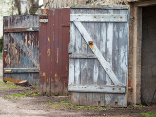 Three weathered and open, wooden doors