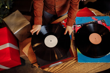 Close up little boy hold music plate, happy family listening vinyl music, parents with cute son...