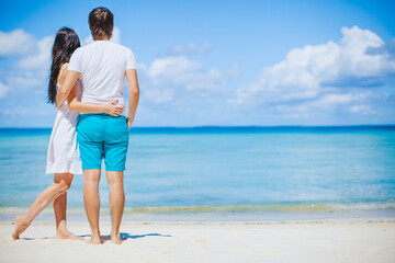 Young couple on white beach during summer vacation.