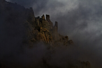 Dark clouds and fog surround spires on Mount Lemmon in Arizona