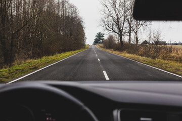 first-person view of an autumn asphalt road, travel by car