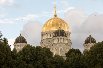 Fototapeta na wymiar Orthodox church with a gold plated roof during golden hour