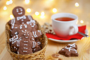 Christmas gingerbread with a mug of tea on a wooden holiday table selective focus background blurred.