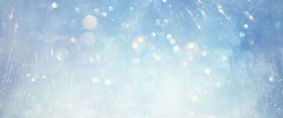 glitter vintage lights background. silver, blue and white. de-focused