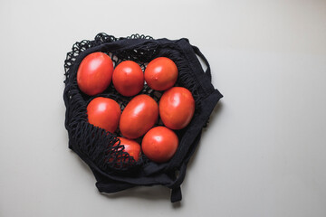 Cloth bag with red tomatoes on the counter