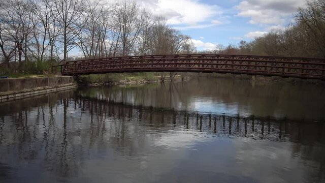 Metal bridge over the canal, reflection of the bridge in the water, NJ