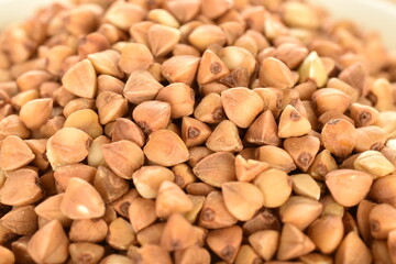 Uncooked organic tasty buckwheat, close-up.