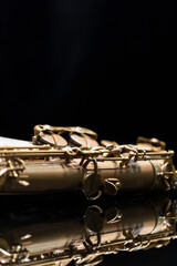 Vintage saxophone on a reflective surface