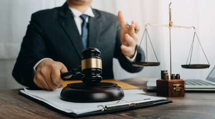 Business and lawyers discussing contract papers with brass scale on desk in office. Law, legal services, advice, justice and law concept picture with film grain effect