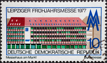 GERMANY, DDR - CIRCA 1977 : a postage stamp from Germany, GDR showingthe fair building on the market, Leipzig, book fair. Leipzig Spring Fair 1977.