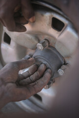 Obraz premium closeup animal photography - two white and red cats - adult and kitten, playfully fighting, outdoors on a handmade brown palm tree seat, on a sunny day in the Gambia, Africa