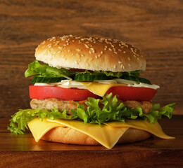 hamburger with meat, cheese, salad and vegetables