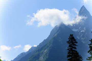 Mountain peaks of glacial mountains stretching into the sky. Difficult mountain route.