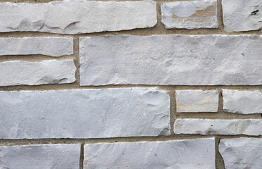 Background of Limestone wall background, light grey limestone with dark tan grout