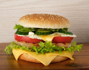 hamburger with meat, cheese, salad and vegetables