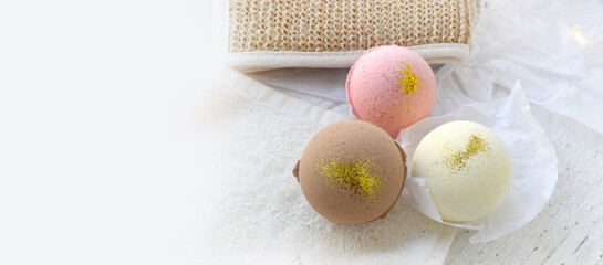 Bath bombs with towel on light romantic background. Beauty wellness, body care cosmetic treatment....