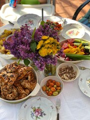 Flowers on the table with dinner, vertical