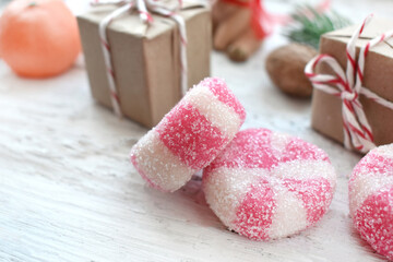 Christmas composition with peppermint candies and gifts on white background. Close up homemade traditional sweets.