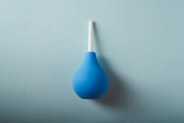 Blue enema on a blue background, top view