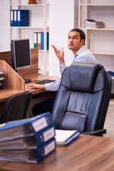 Young male employee working in the office