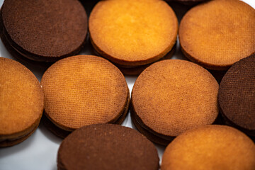 Round roast with chocolate in confectionery on a black background