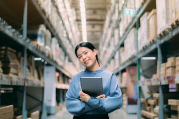 Portrait Young energetic smart Asian business working woman smile use digital tablet to check inventory data for product management  in warehouse, Logistics business planning concept with copy space