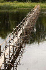 A narrow wooden pathway over a river