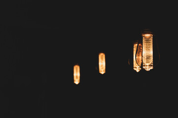 Hanging Vintage bulbs with warm orange light.