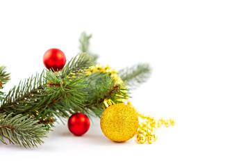 Christmas background. Red and gold christmas decorations and fir tree branch on white background. Top view with copy space.