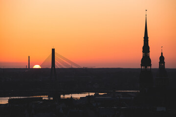 Fototapeta premium sunset over the capital of Latvia, Riga, top of the churches violet sky