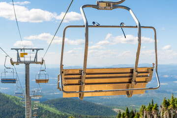 An empty ski lift not operating during summer at a Spokane State Park ski resort overlooking the Spokane, Washington area, USA