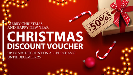 Red Christmas discount voucher with presents with price tag, candy canes and garland frame, top view