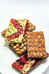Chocolate bar with the addition of fruit nuts on background. Dessert food concept.