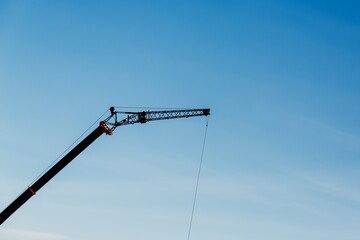 Black crane and clear blue sky. Details, fragment